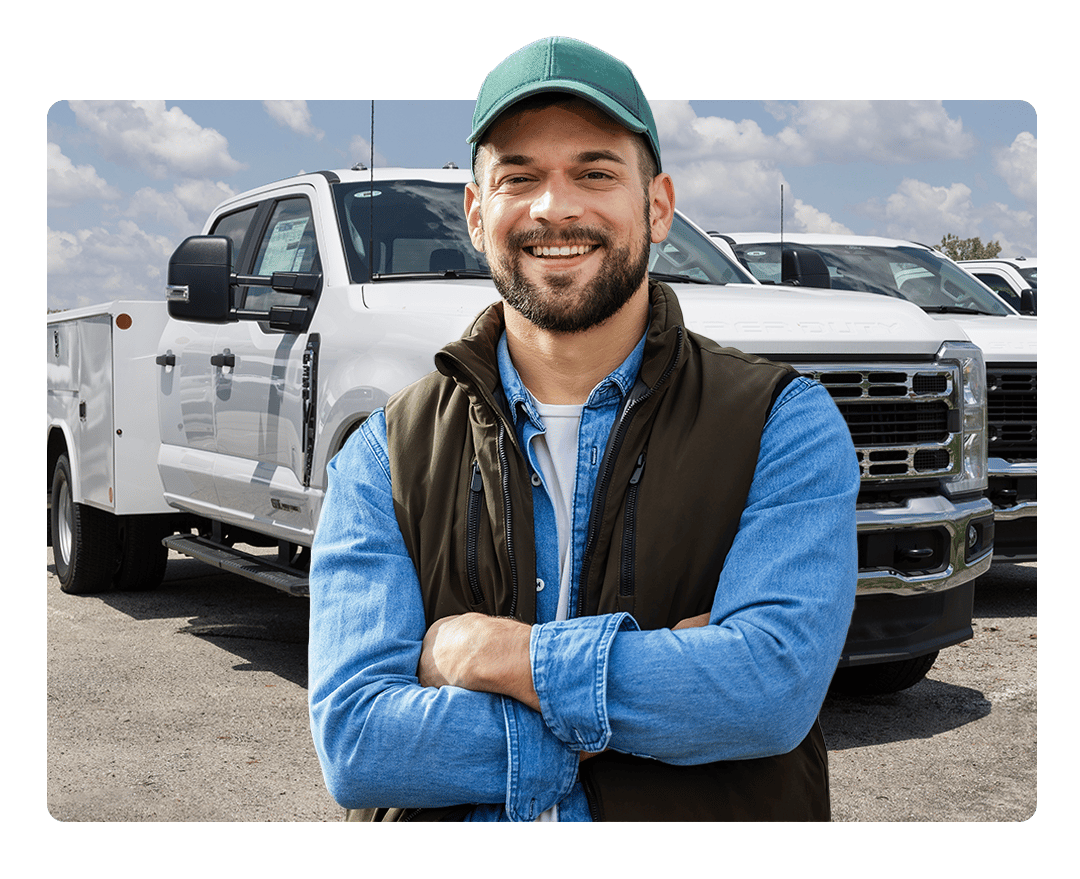 Government Fleet Manager Standing in front of Truck Fleet